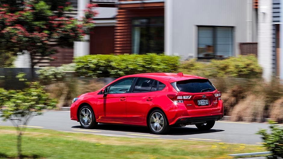 2016 Subaru Impreza 2.0 Sport driving past houses