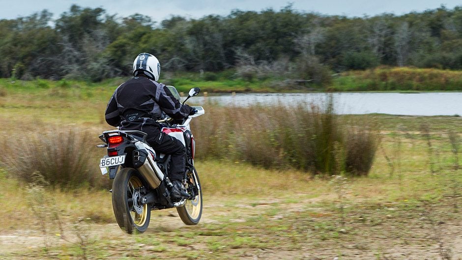 Honda Africa Twin riding through scrub