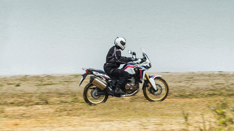 Honda Africa Twin riding past lake