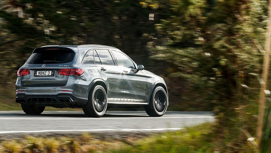 2020 Mercedes-AMG GLC 63 S driving past trees
