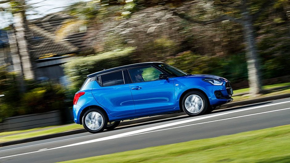 Suzuki Swift Hybrid driving through town