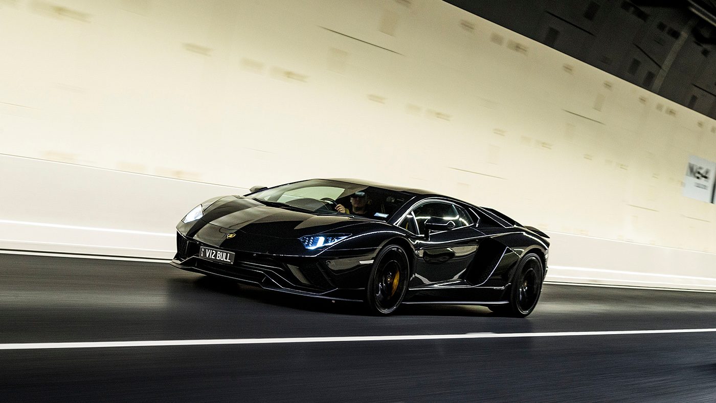 Lamborghini Aventador S front three quarter view driving through tunnel