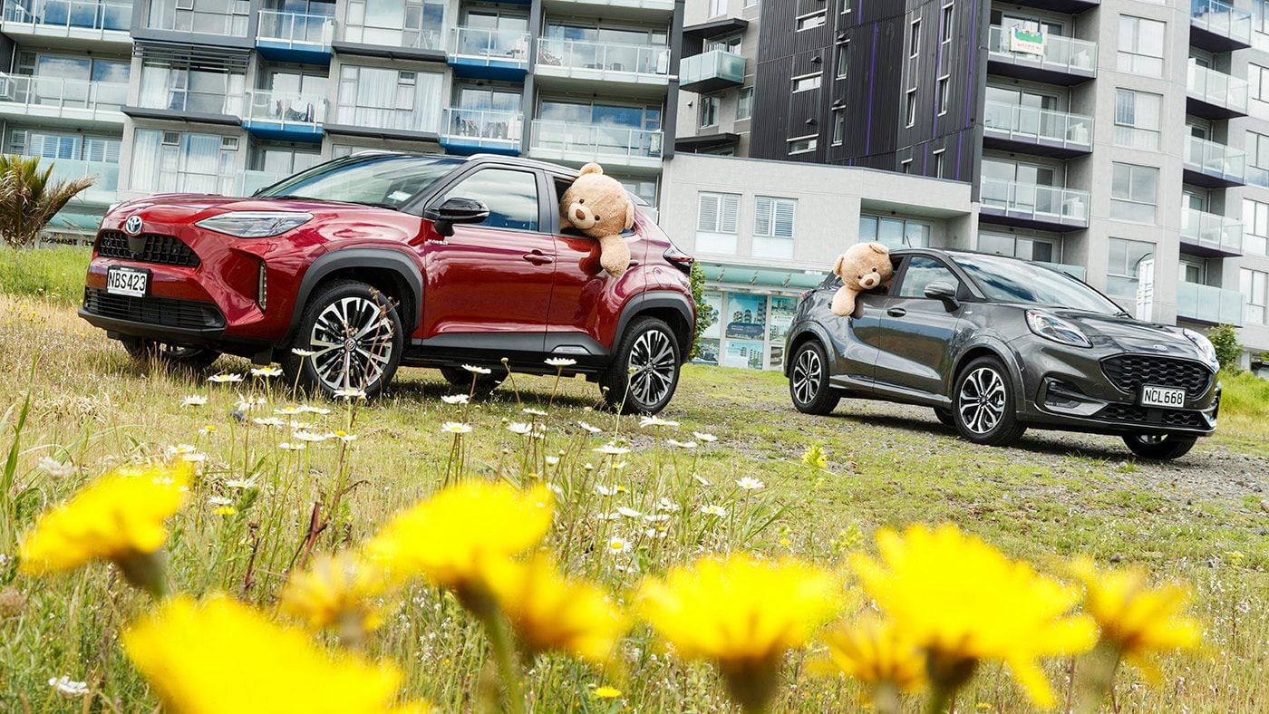 Ford Puma vs Toyota Yaris cross parked in front of apartments