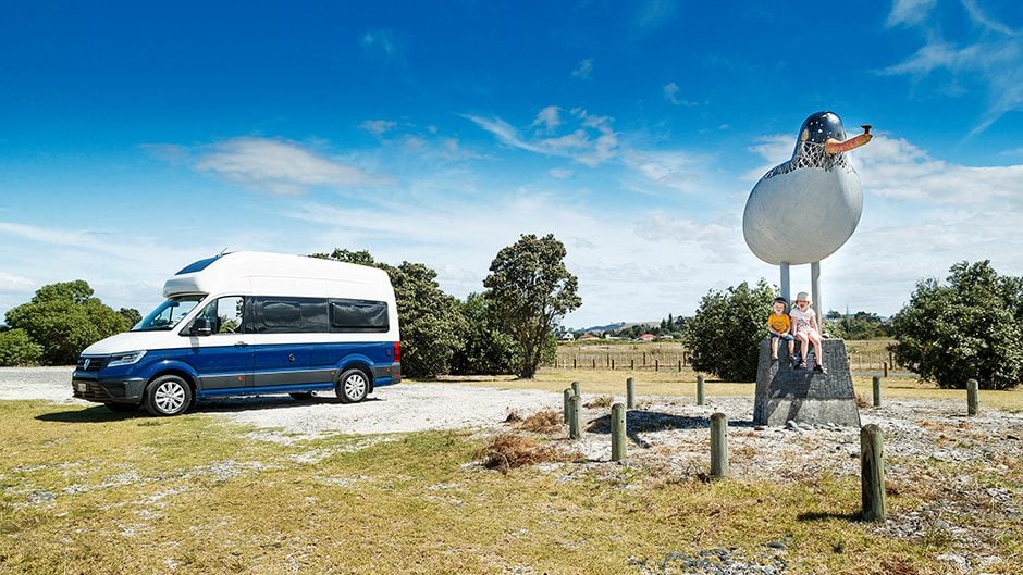 2020 Volkswagen Grand California 600 parked next to giant bird statue