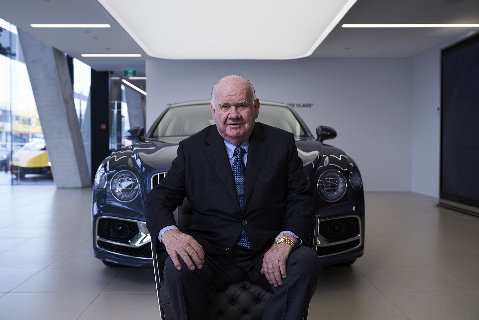 Sir Colin Giltrap sitting in front of Bentley