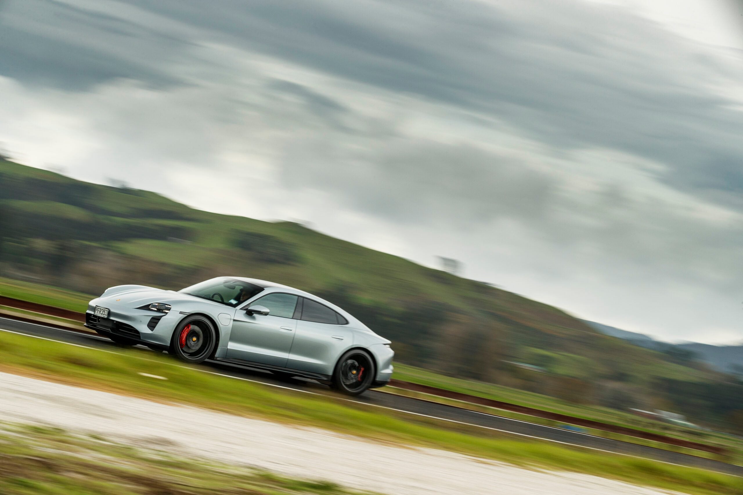 Porsche Taycan GTS driving through countryside