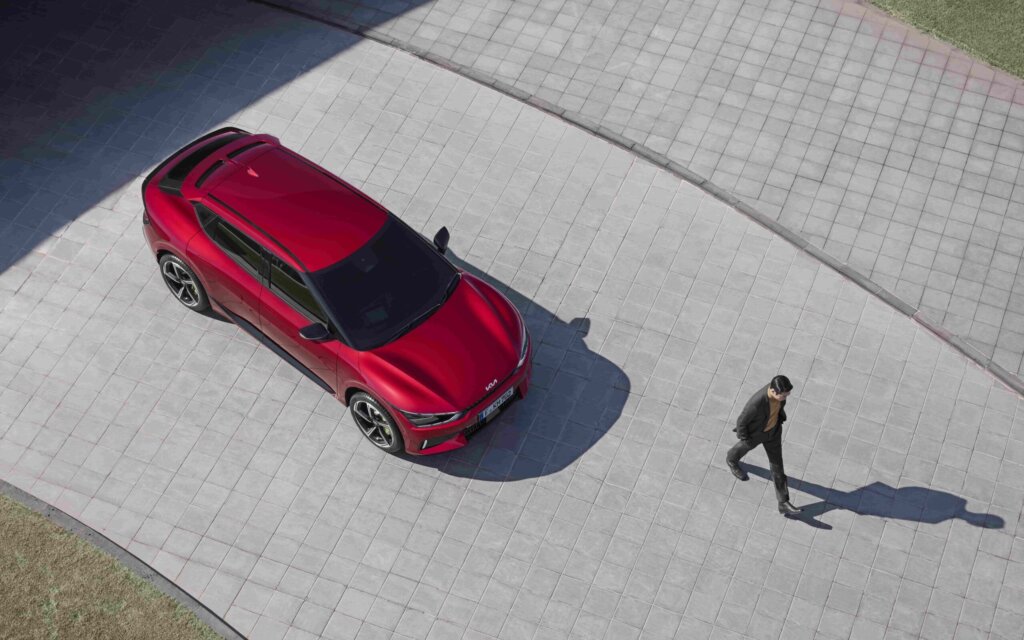 Man walking away from Kia EV6 GT top down view