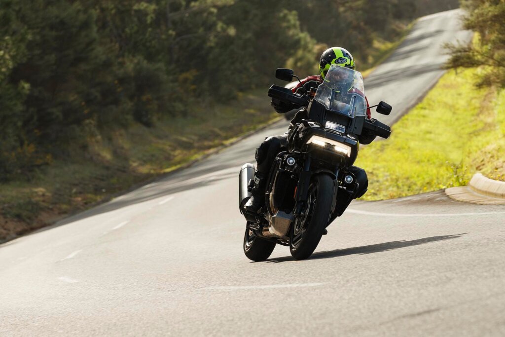 2022 Harley-Davidson Pan America riding through sunny corner