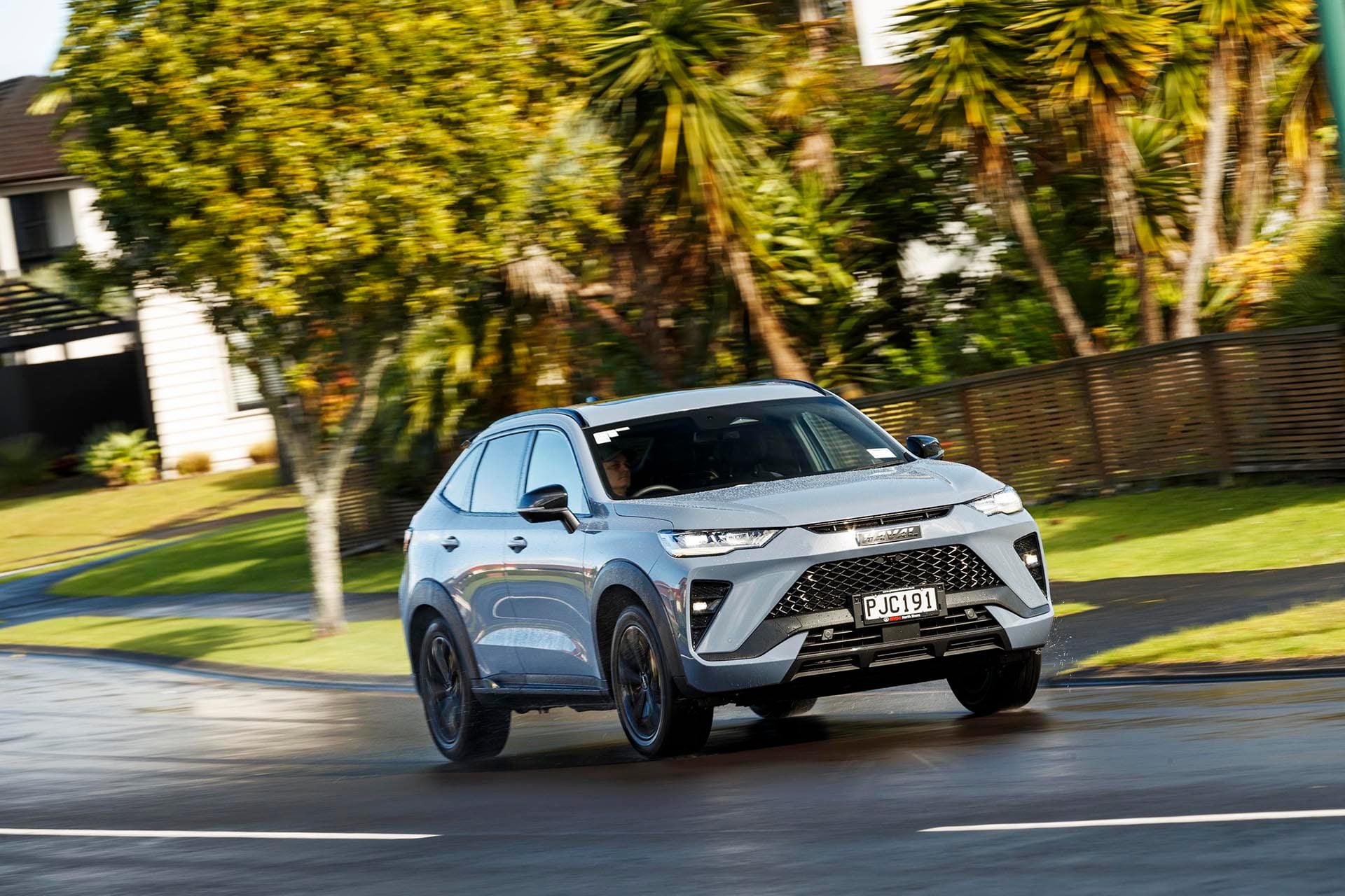 2022 Haval H6GT Ultra 4WD driving past houses
