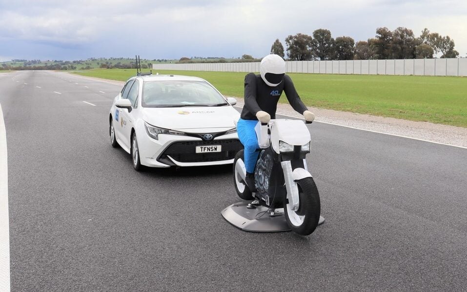 Toyota Corolla behind bike safety dummy