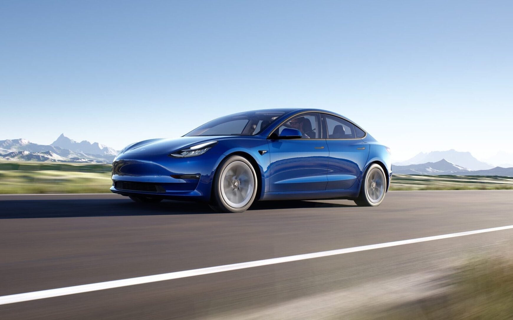 Tesla Model 3 front three quarter view driving