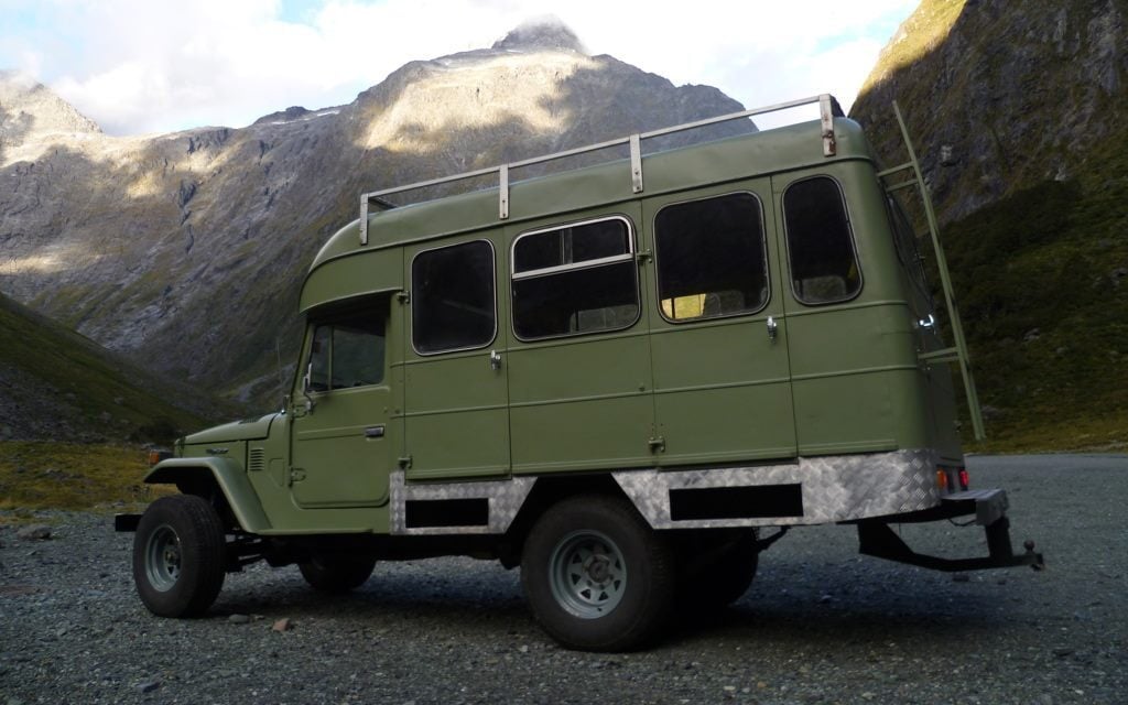Toyota Land Cruiser camper side view in mountains