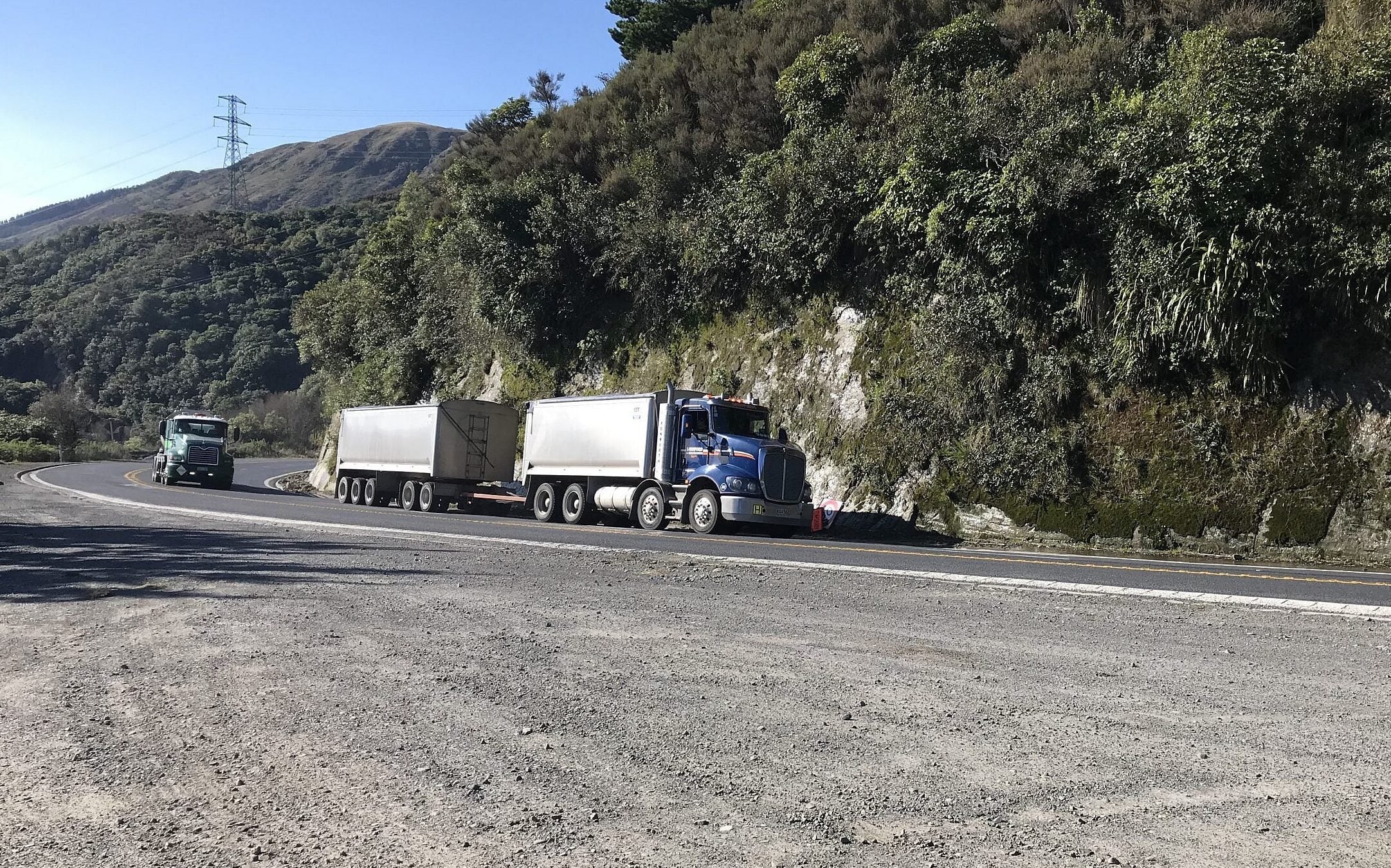 Trucks driving up hill in New Zealand