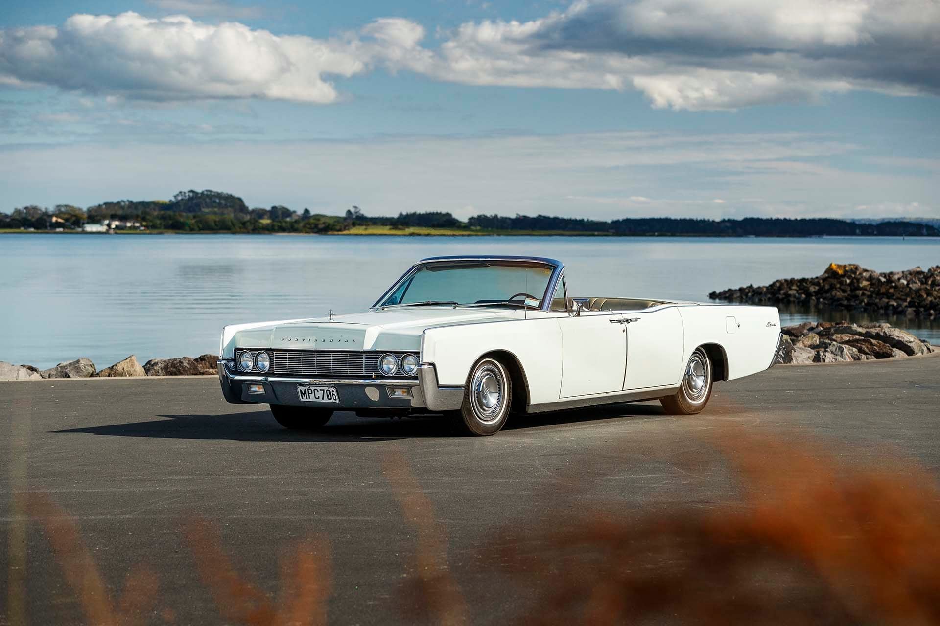 1967 Lincoln Continental Convertible in front of water
