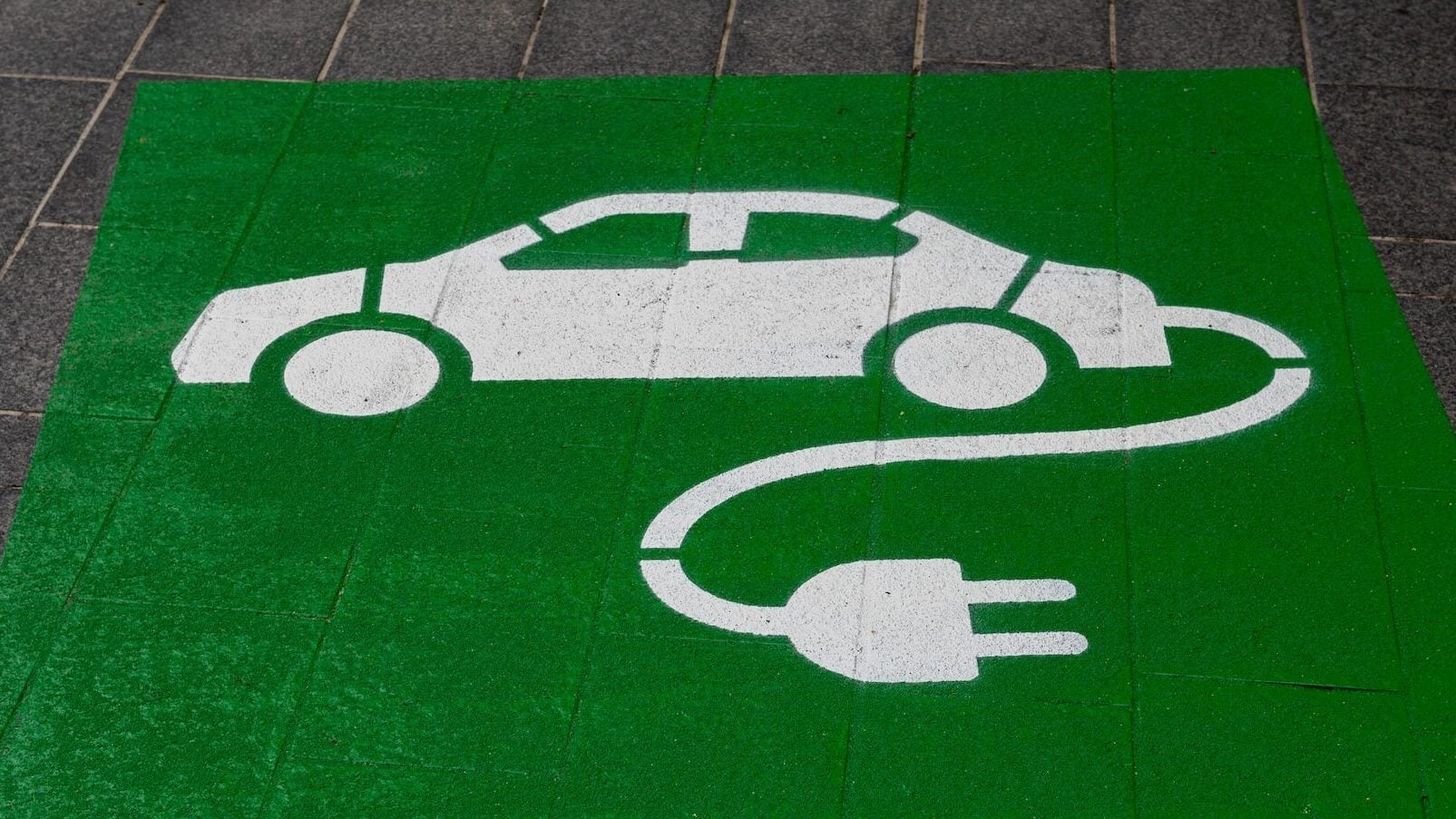 Electric vehicle charging icon on ground