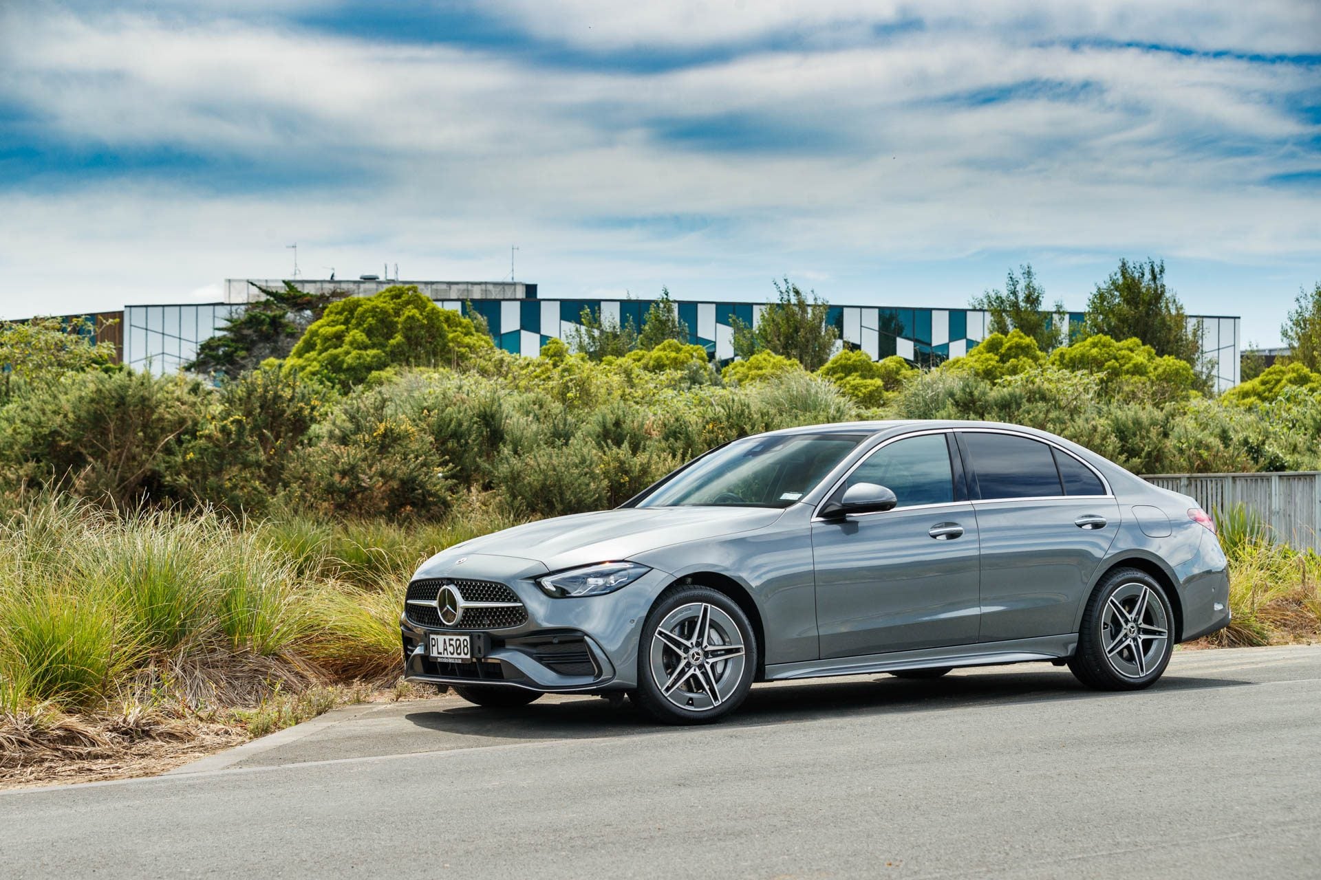 Silver Mercedes C 350e PHEV parked next to a garden