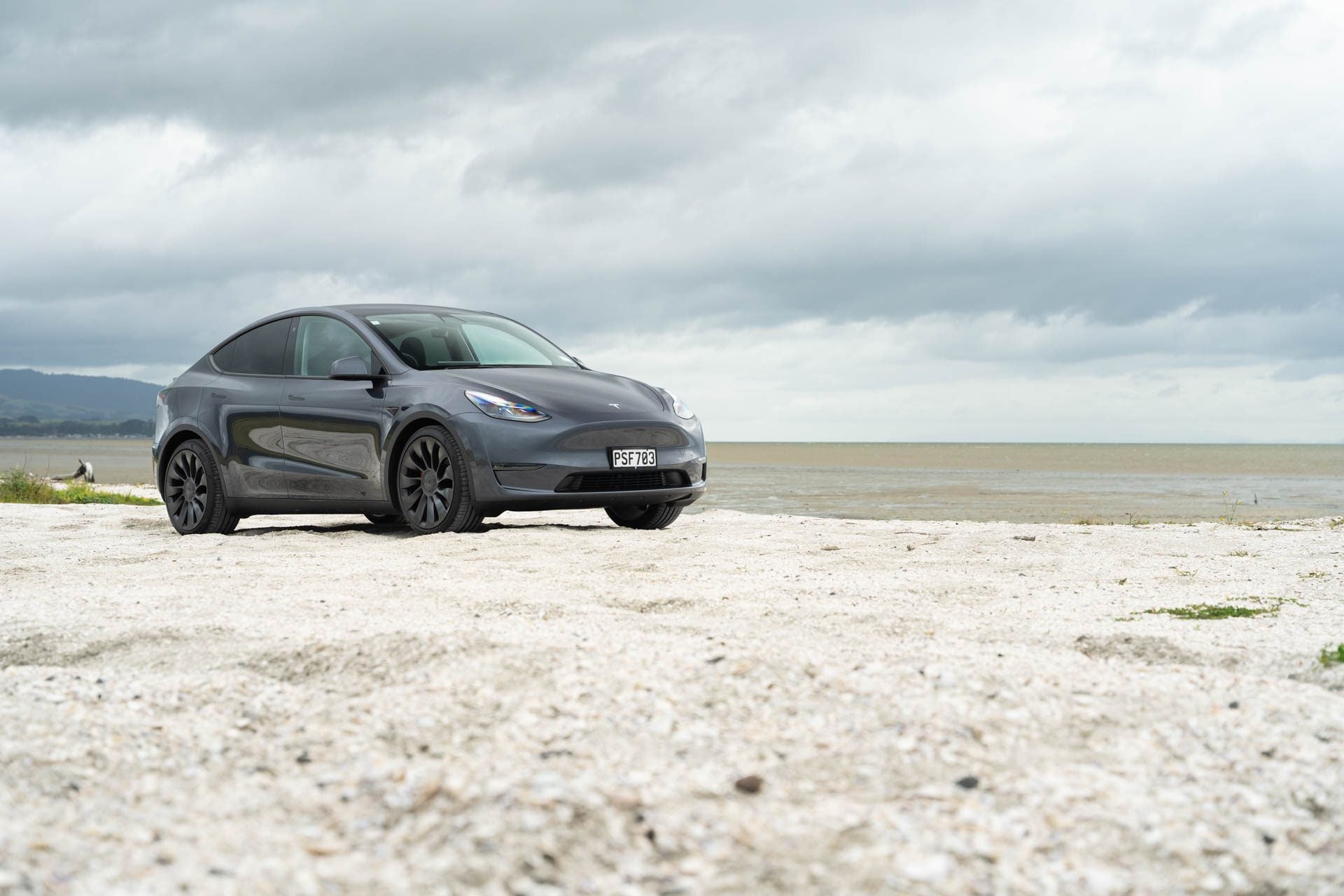 Tesla Model Y Performance parked on white sand