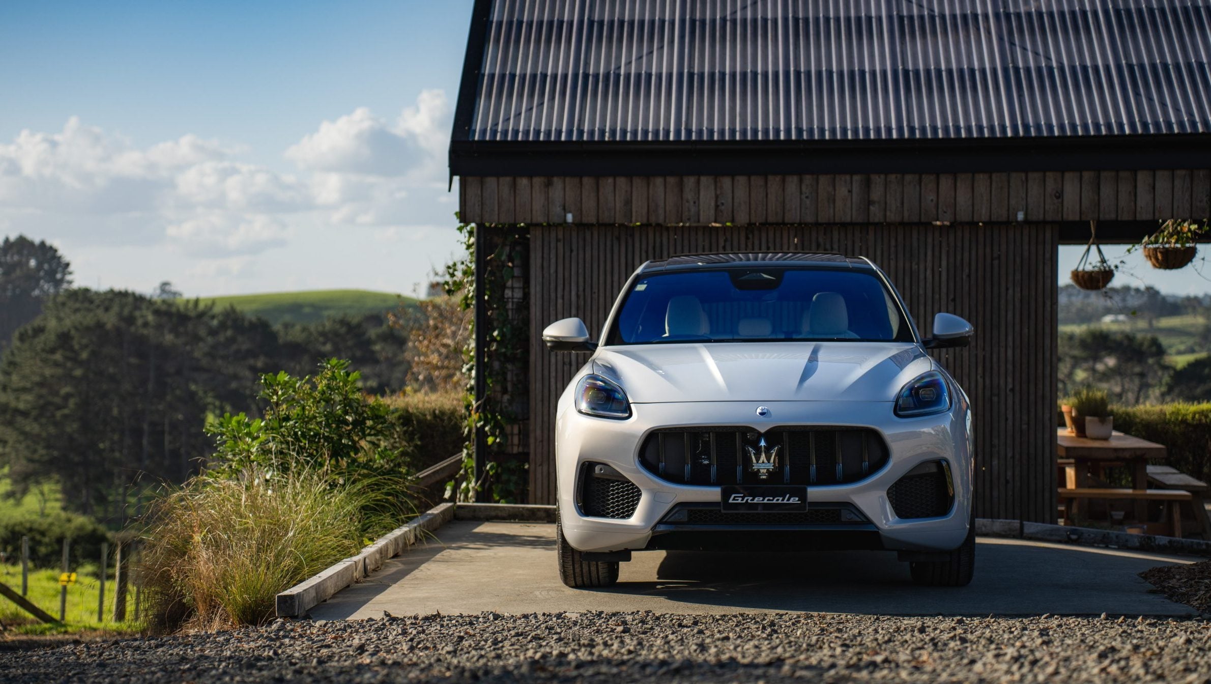 Maserati Grecale parked in front of house in countryside
