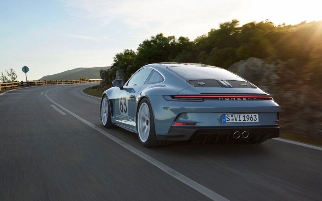 Porsche 911 S/T Heritage Design Package driving on road at sunset