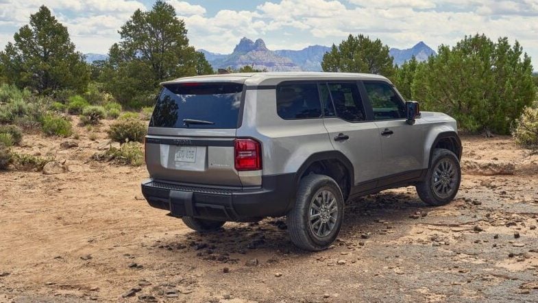 Toyota Land Cruiser Prado driving in desert rear