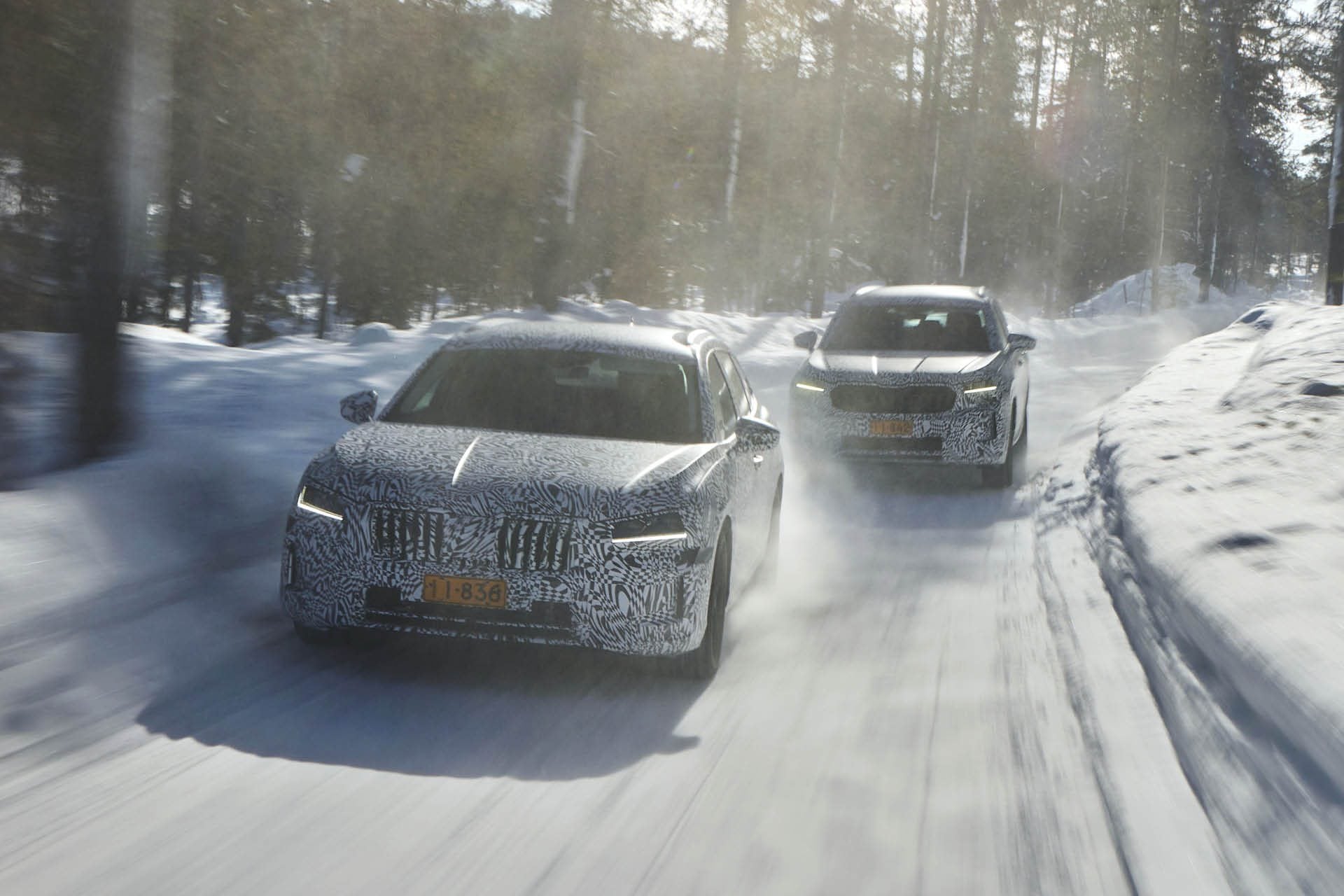 2024 Skoda Superb and Kodiaq driving on snowy road in forest