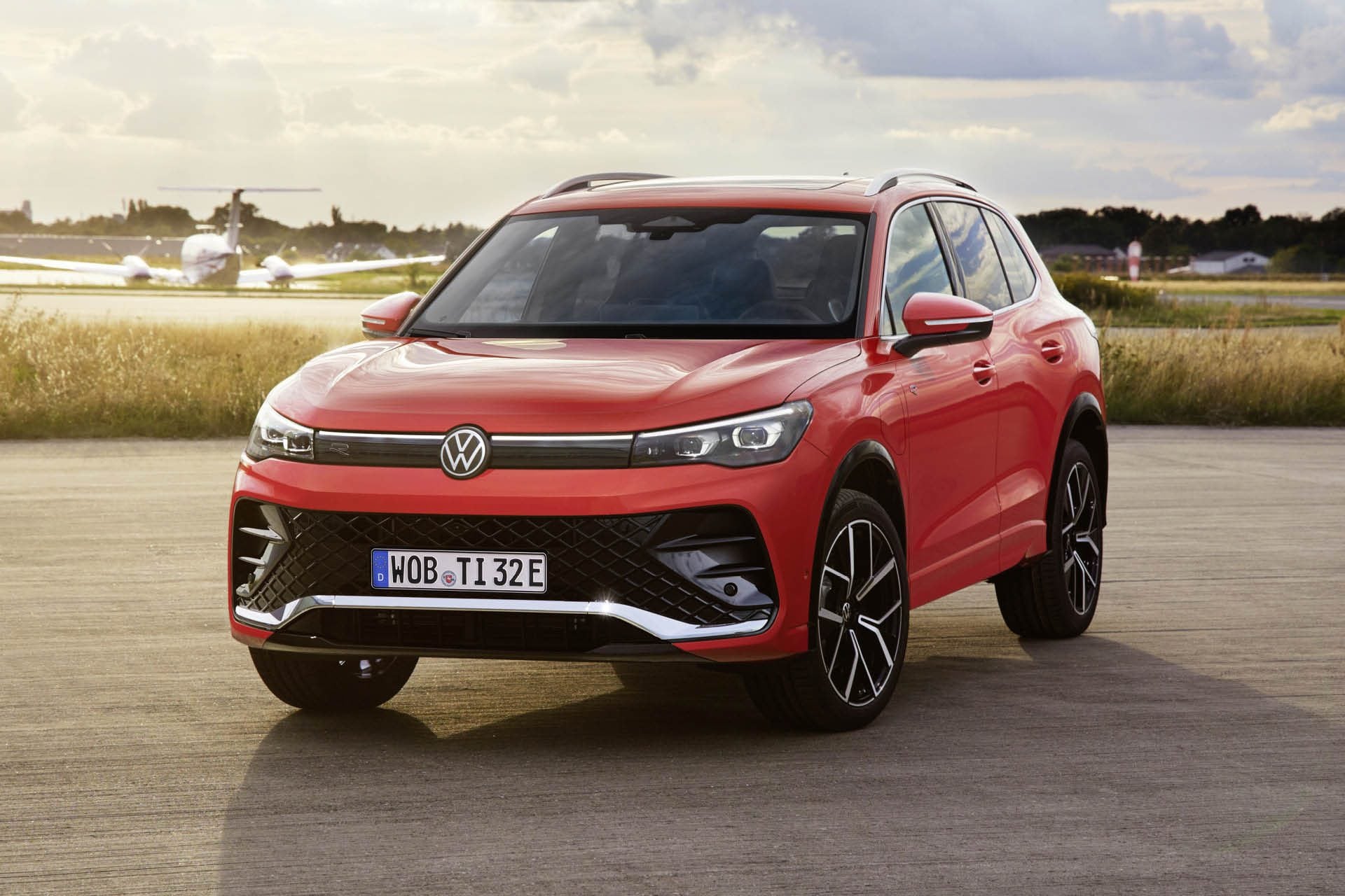 2024 Volkswagen Tiguan parked next to plane