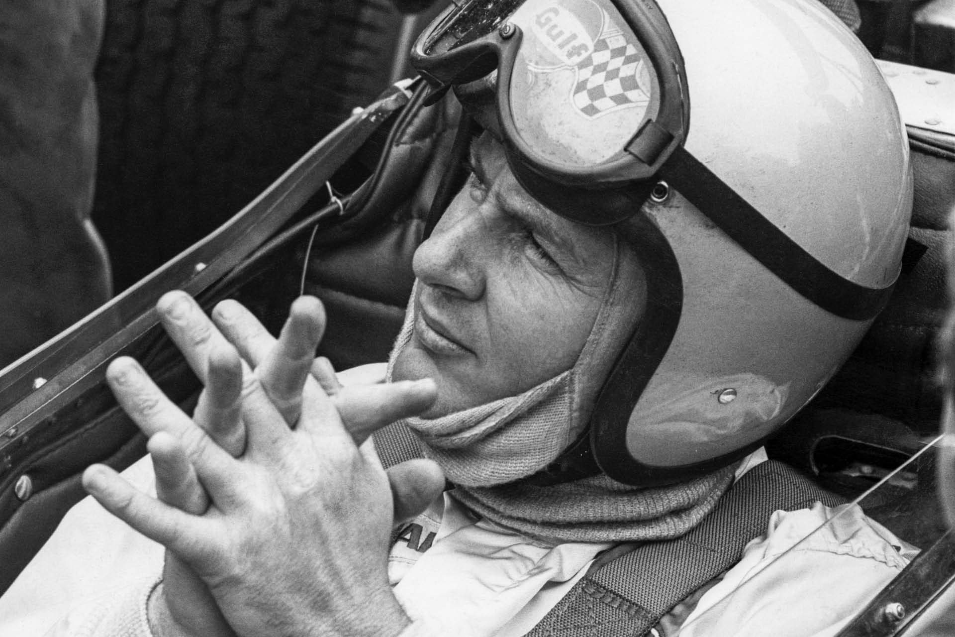 Bruce McLaren sitting in Formula 1 car