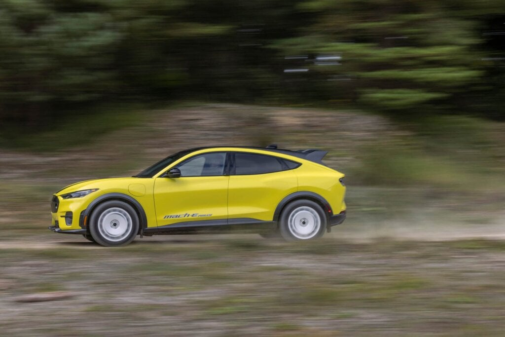 Ford Mustang Mach-E Rally driving on dirt road at speed