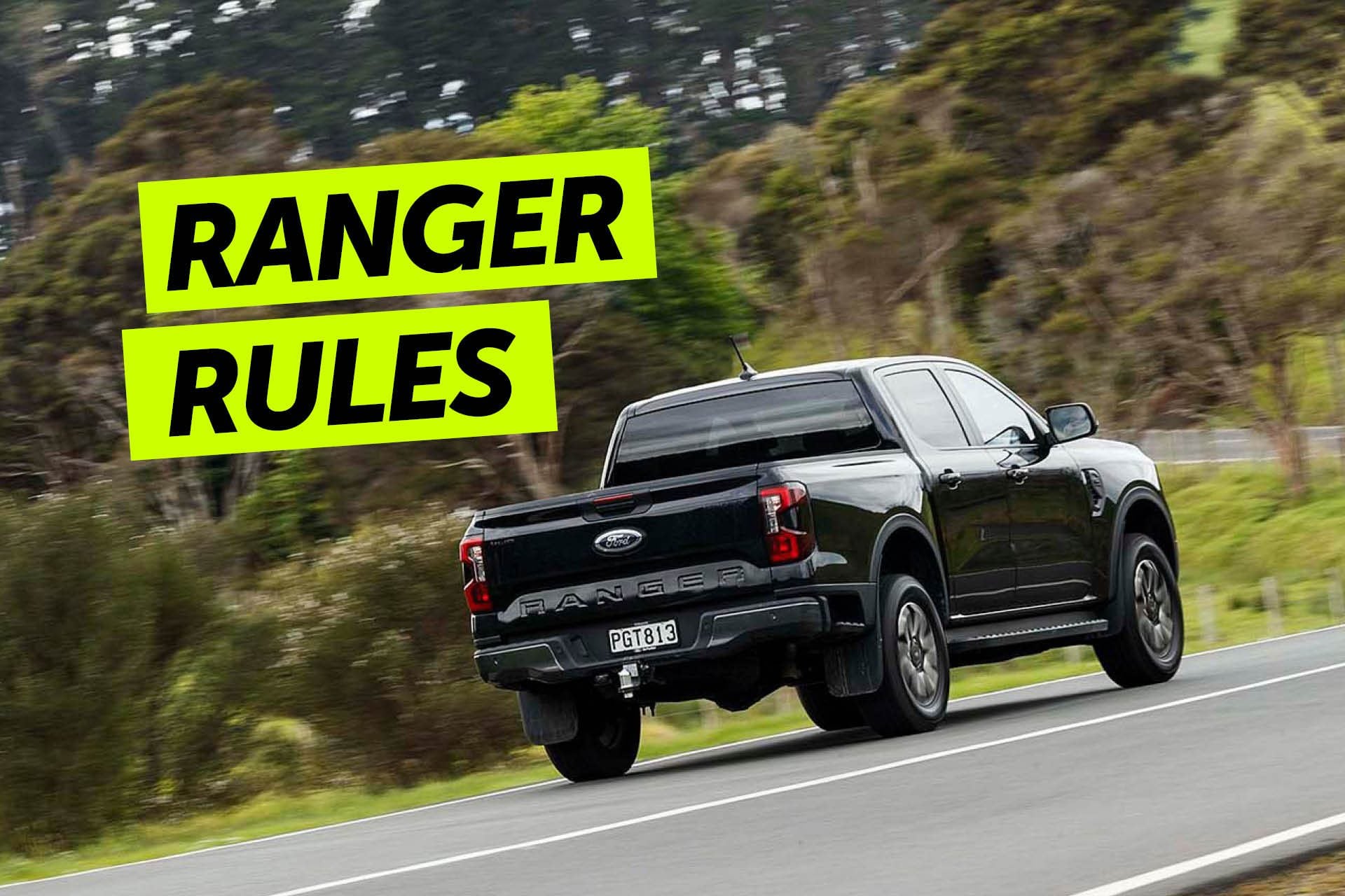Ford Ranger driving on road by trees