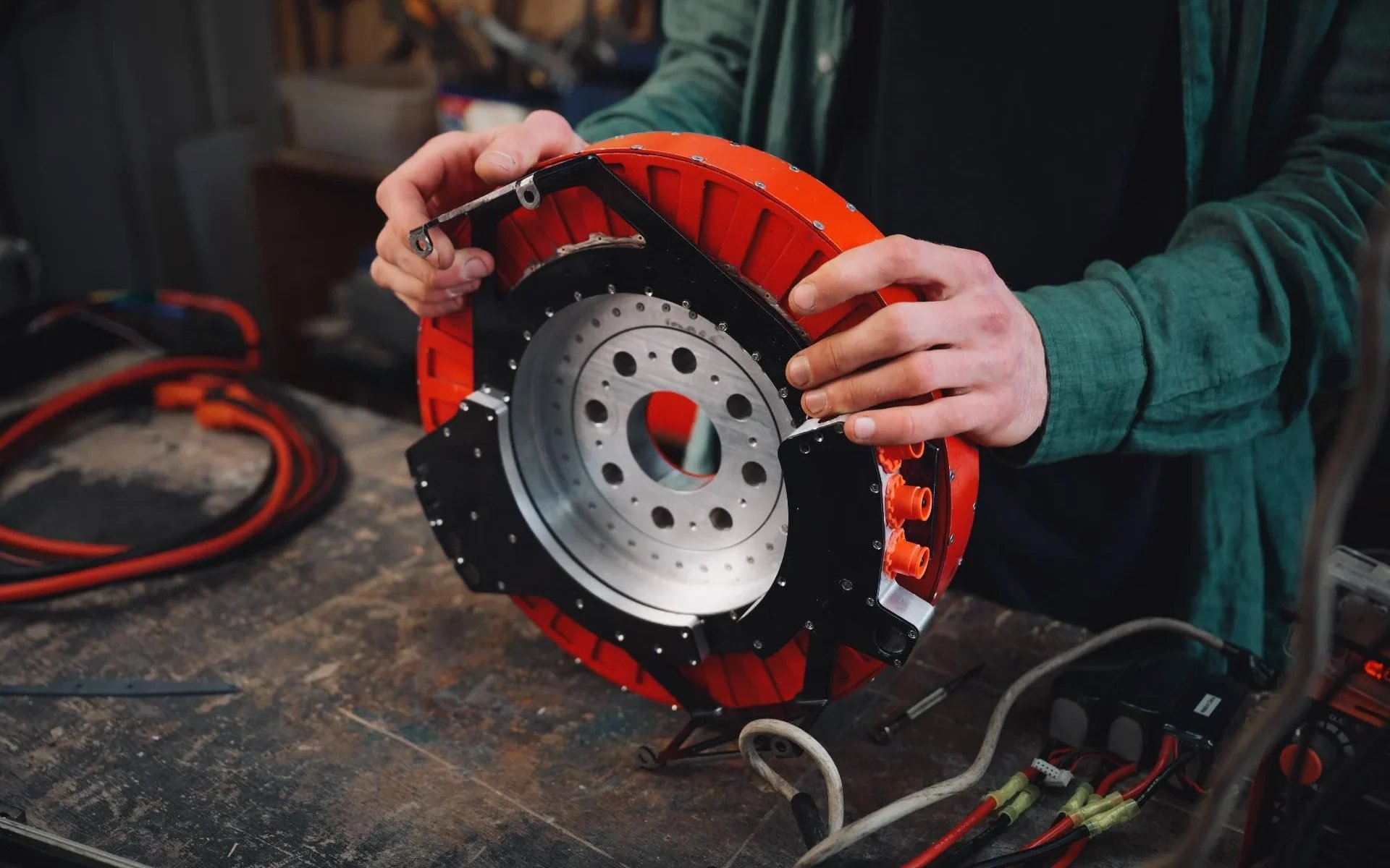 Alexander Burton holding REVR electric motor