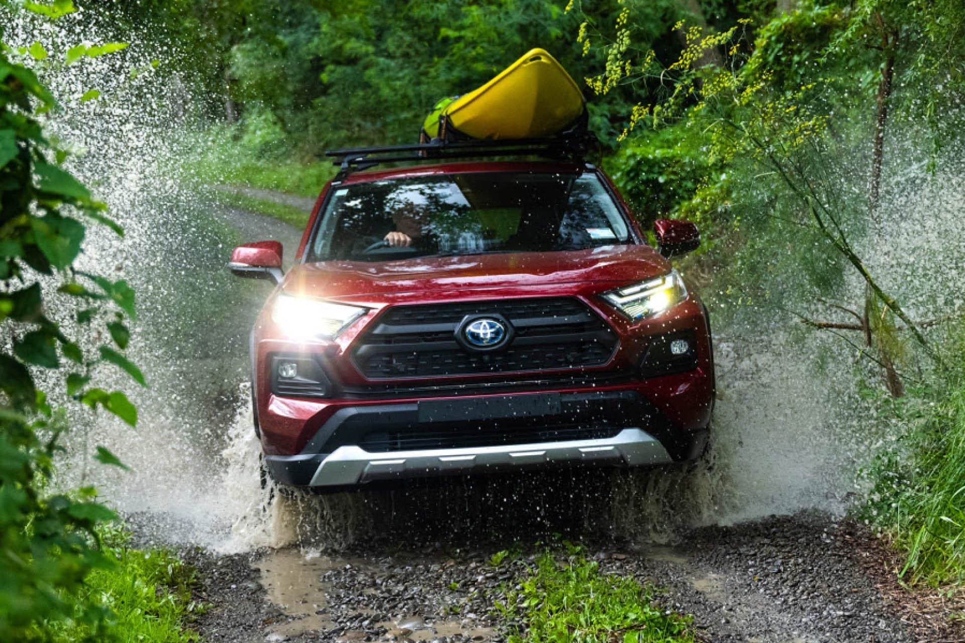 Toyota RAV4 Hybrid driving through river in bush