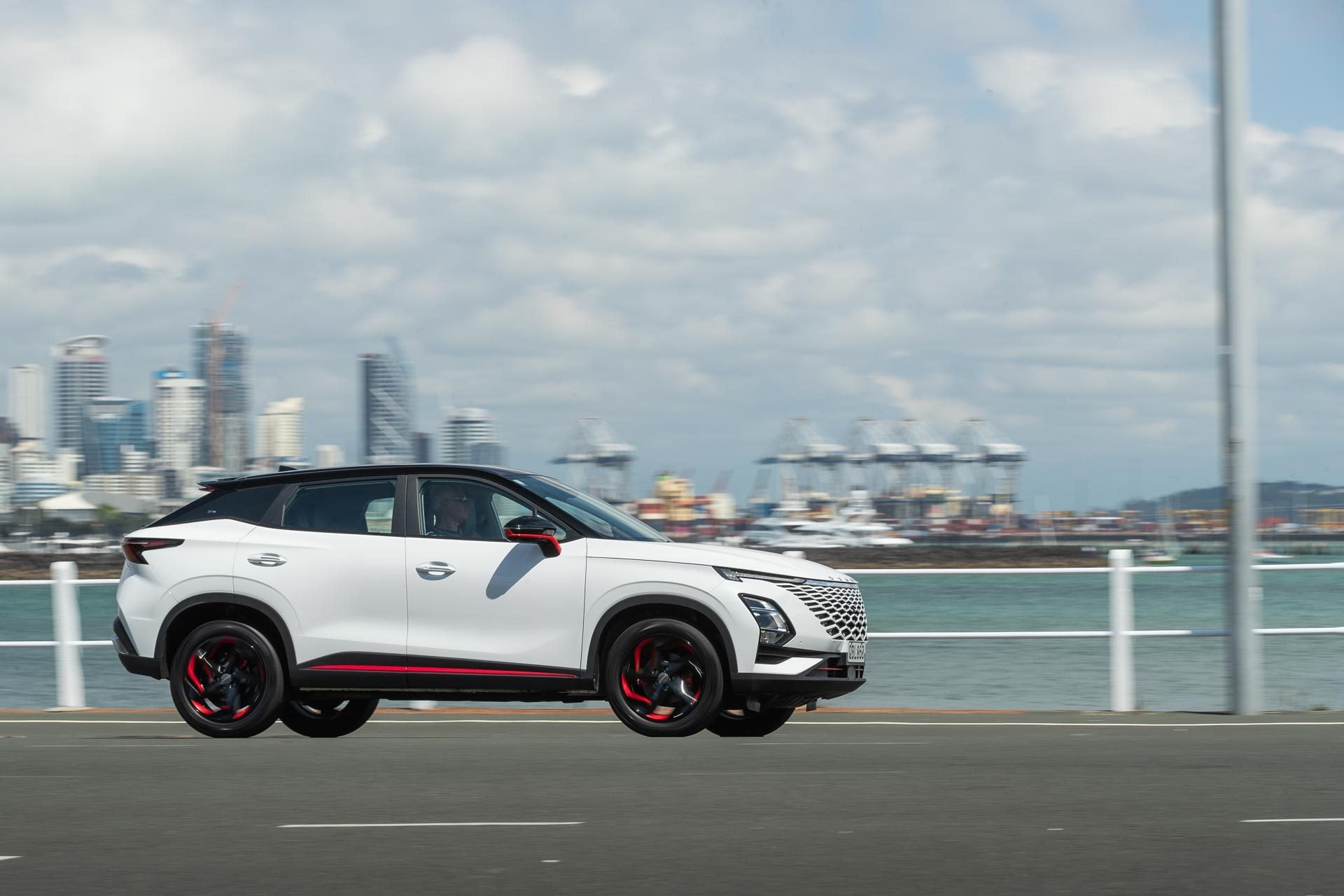 Omoda C5 front panning shot, with Auckland city in background