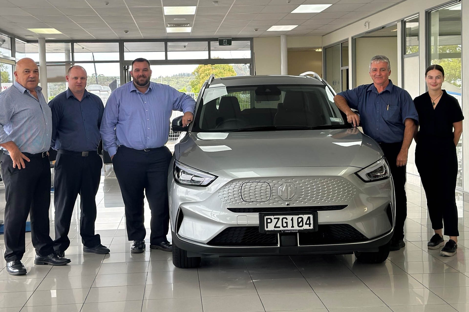 MG Northland team members standing around MG ZS EV