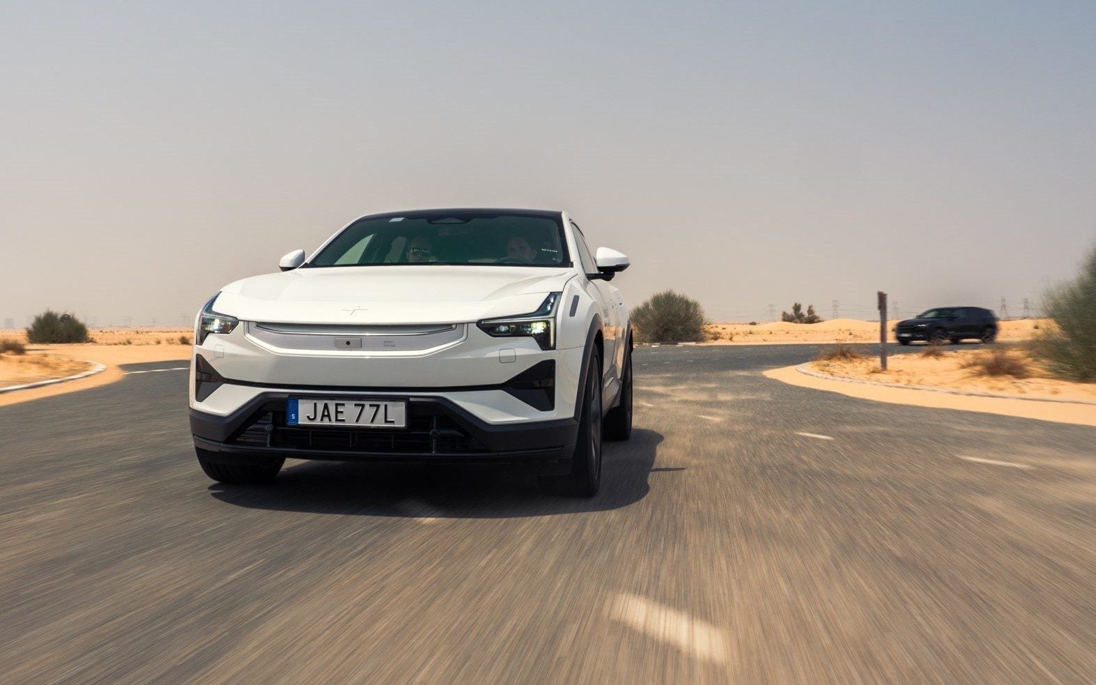 Frontal shot of development car testing on road.