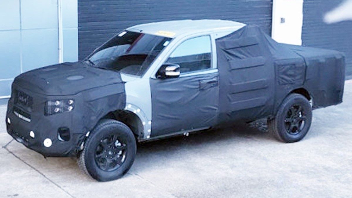 Kia Tasman in true camouflage spy shot.
