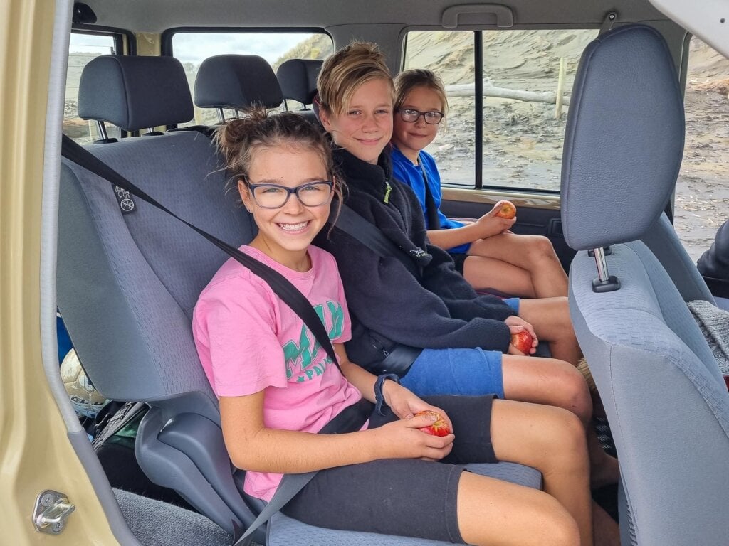 smiling passengers inside the Toyota Land Cruiser 70 LX