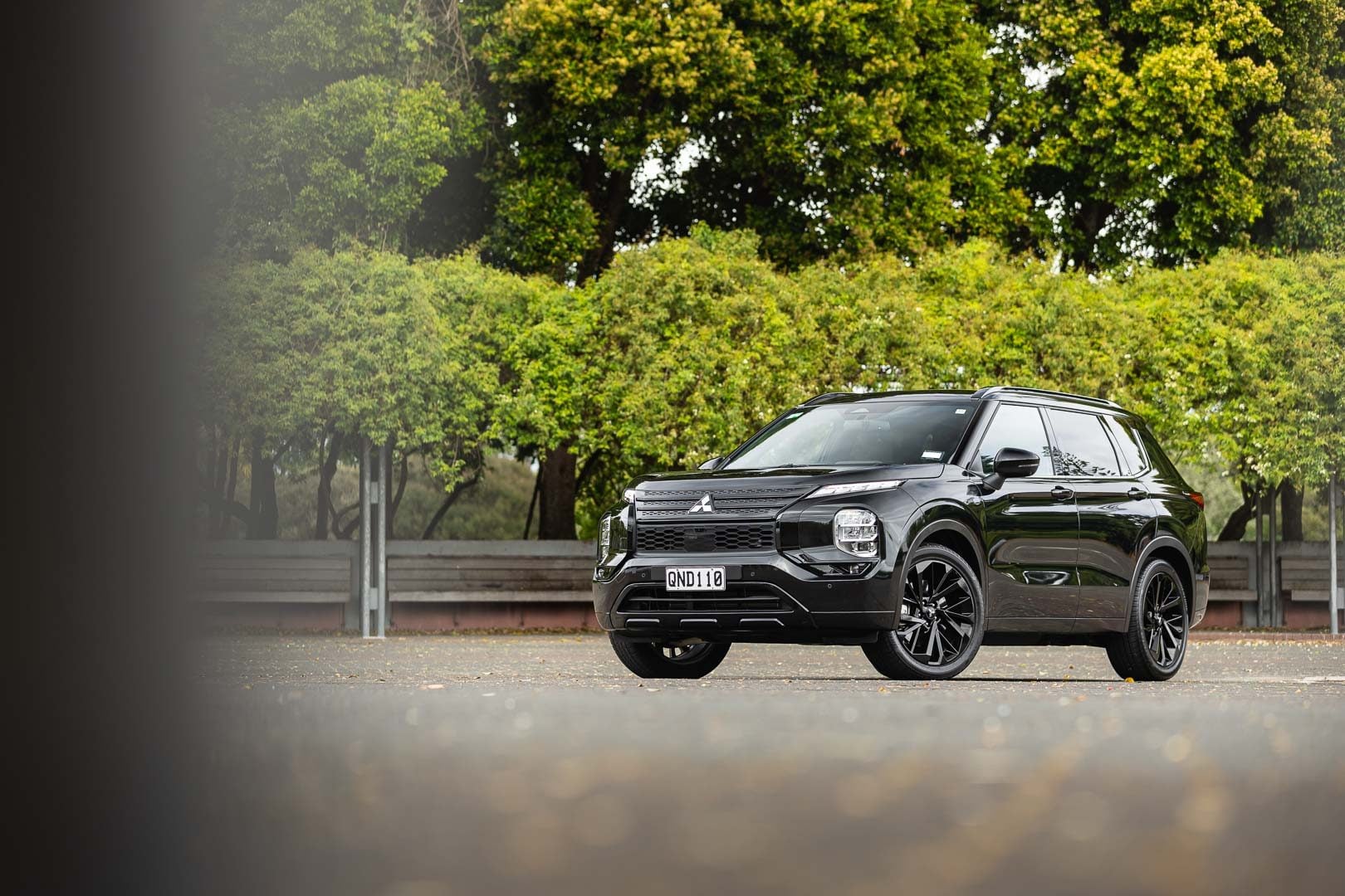 Mitsubishi Outlander in black, parked showing front quarter of car