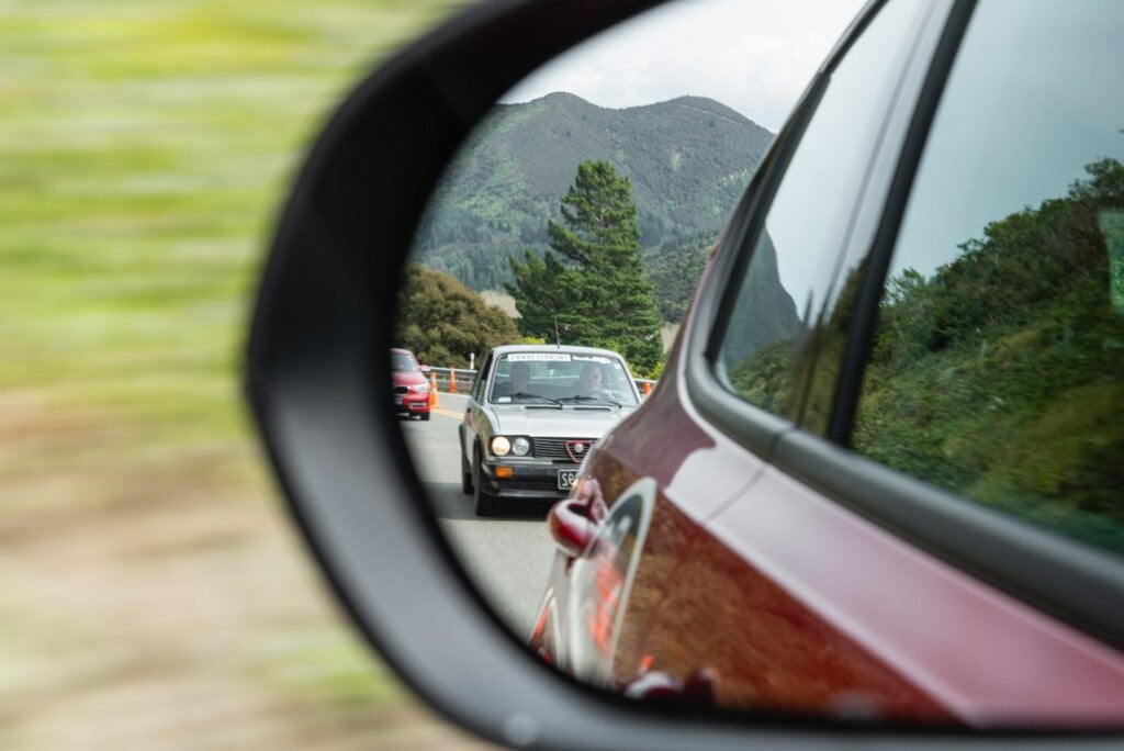 Alfa trailing behind in rear view mirror