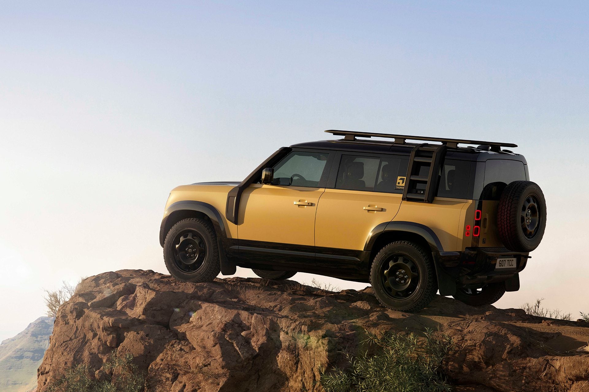 Defender Trophy Edition under clear skies on a rock
