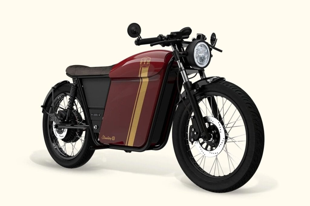 Lots of retro styling going on here, with cafe racer stance, wire wheels, round headlight, and dual rear springs.