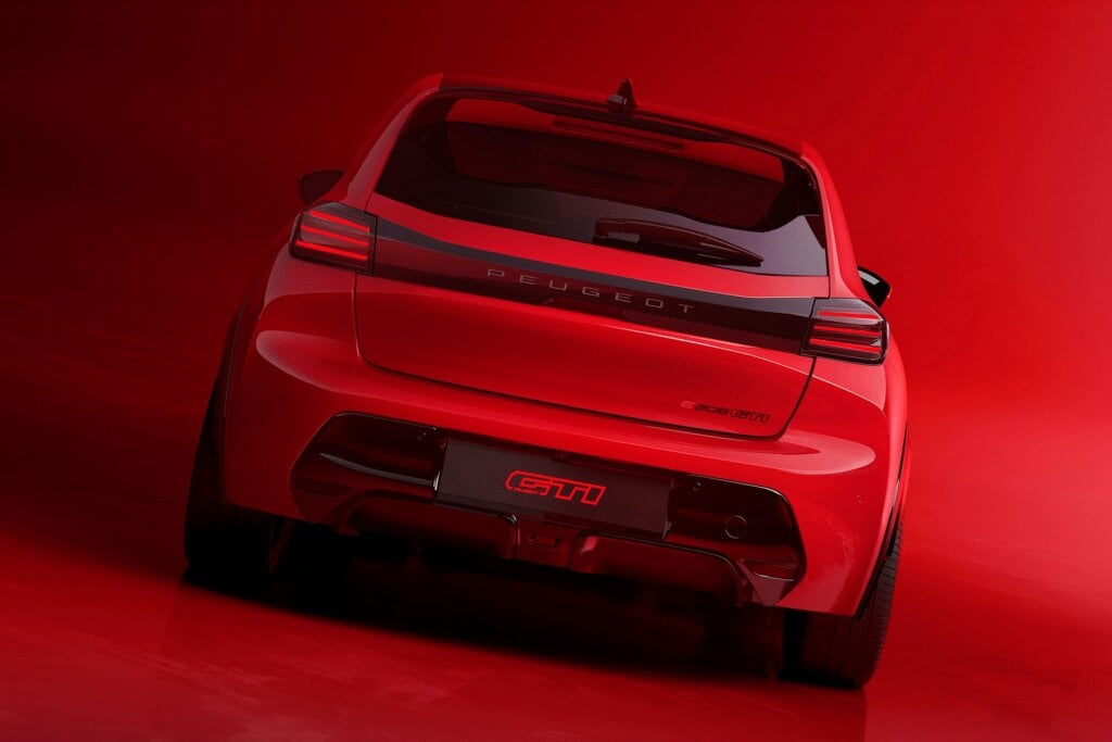 Rear spoiler and diffuser, plus the big badge mark out the hot e208.