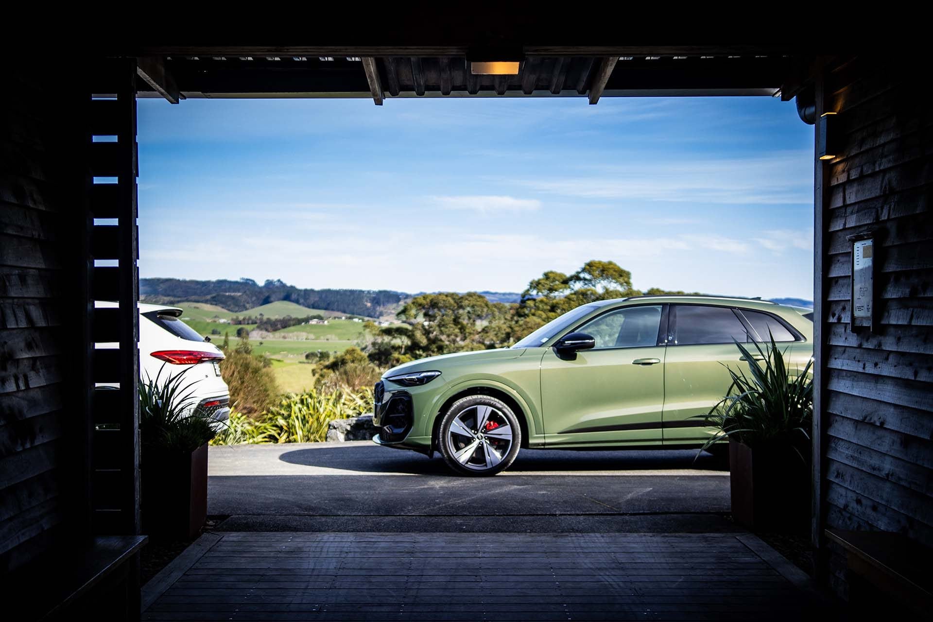 Audi Q5 in green with the countryside in the background
