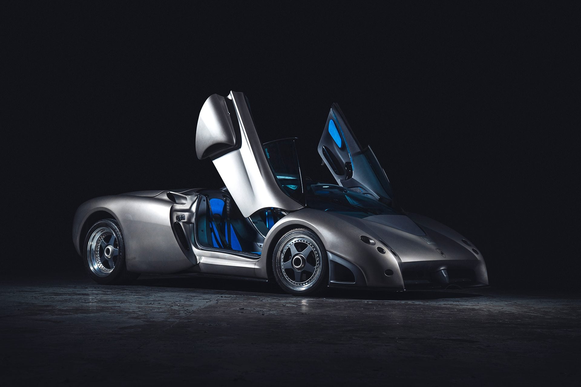 Lamborghini Pregunta with its doors up on a black back ground