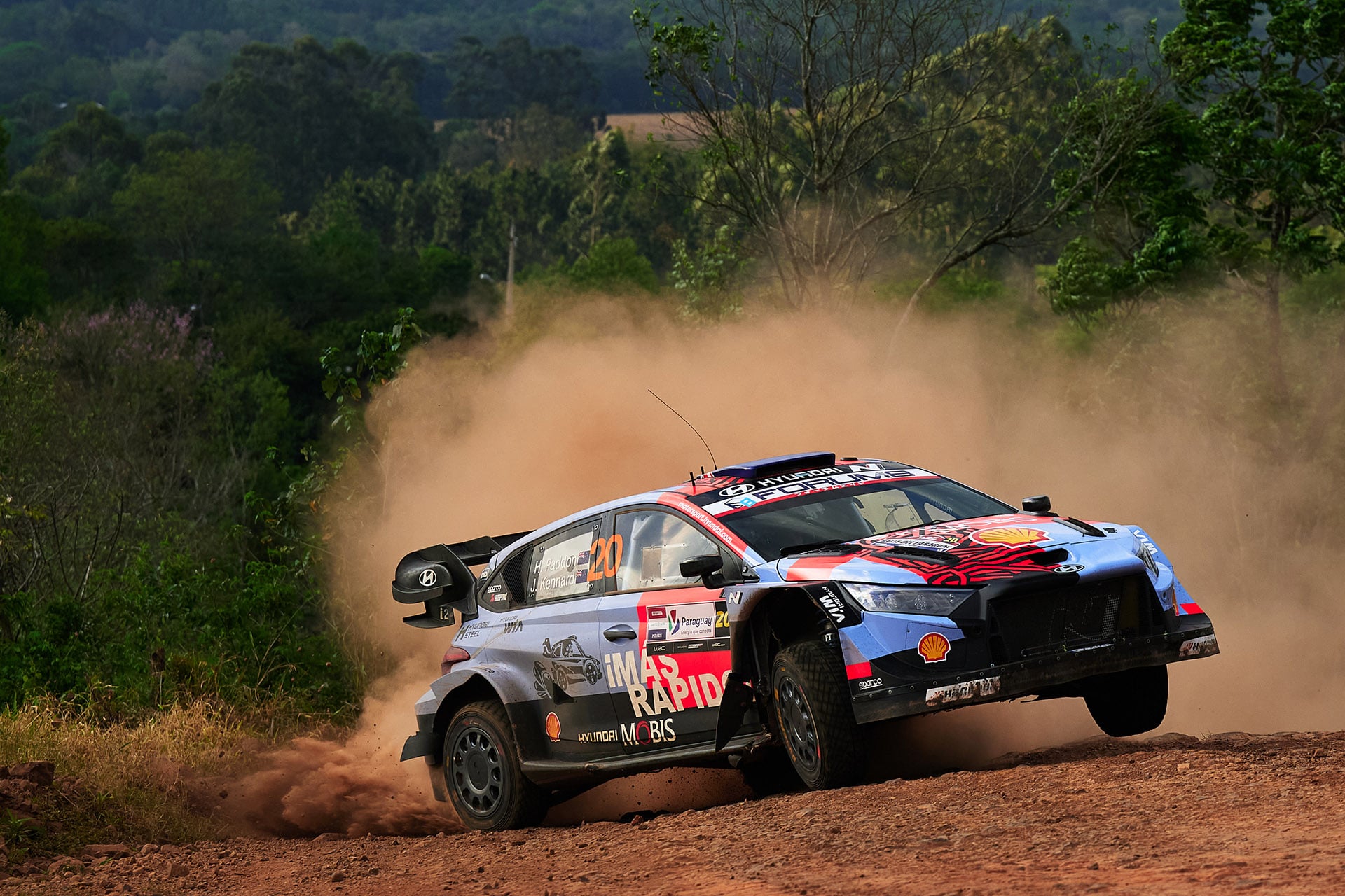 Paddon WRC blue and orange Hyundai on dirt