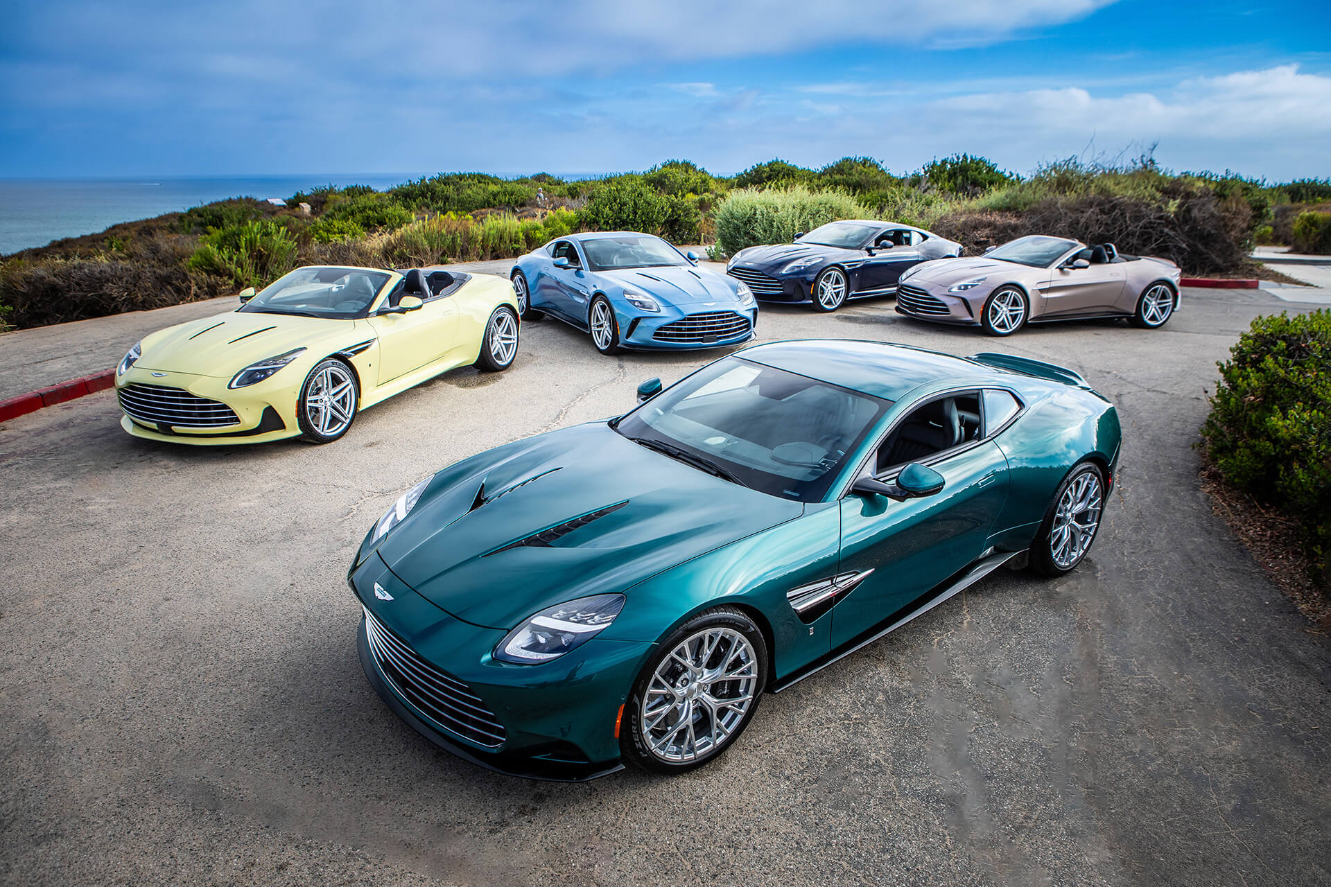 Aston Martins in pastel colours parked on the road