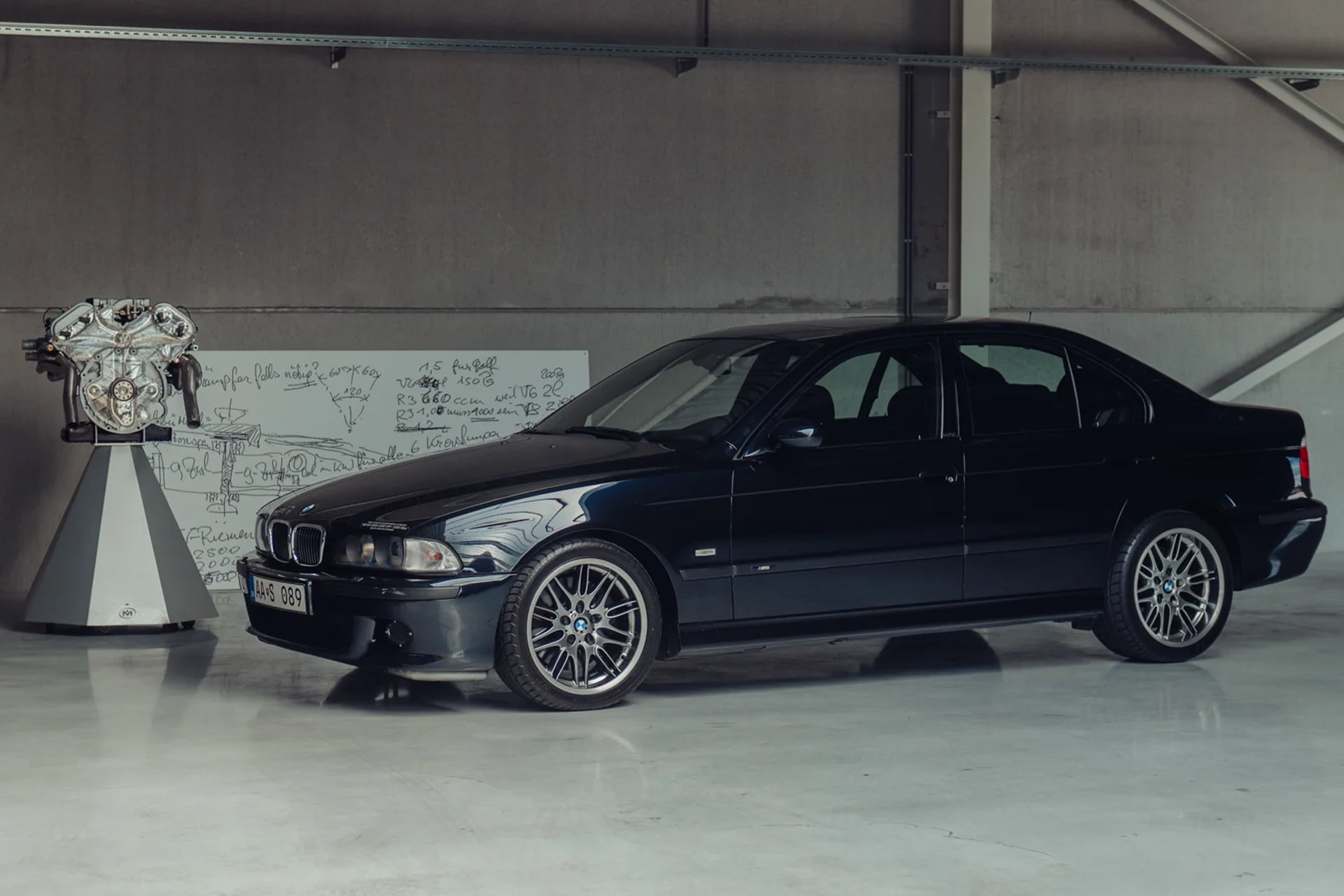 blue M5 in a workshop