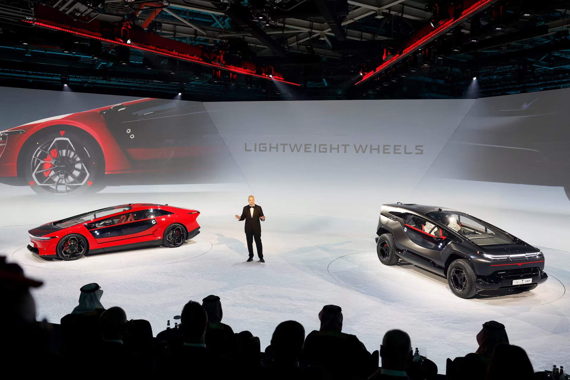 two crazy EVs on a white stage