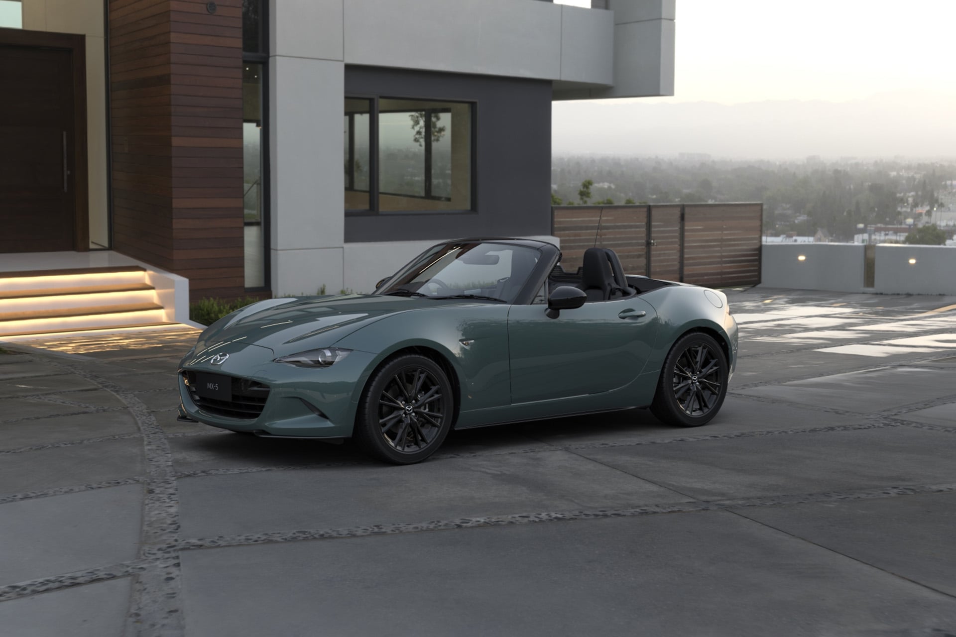 Mazda MX-5 in grey in front of a grey building, on grey tatmac