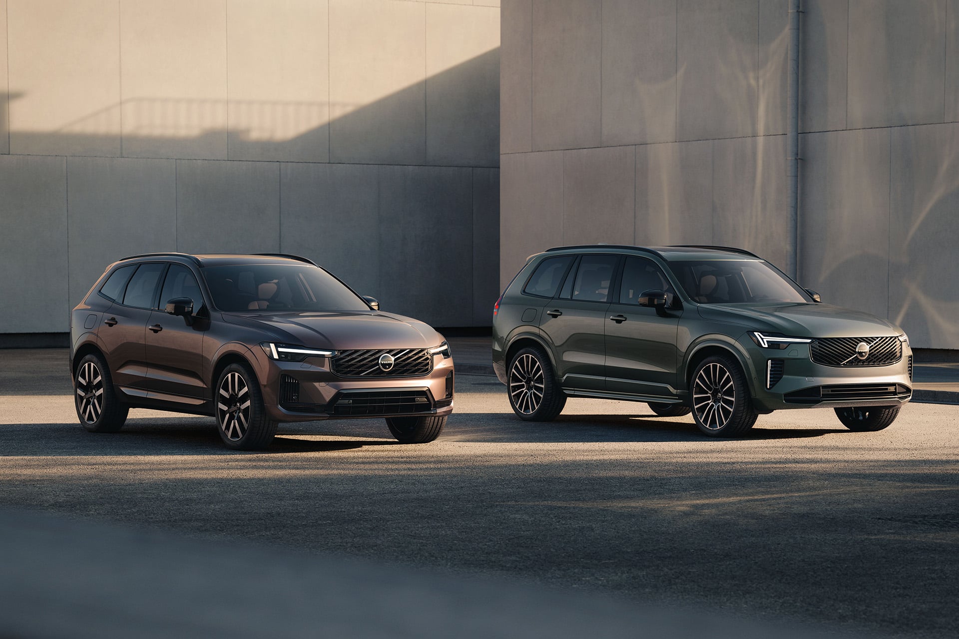 Volvo XCs in brown and green in a concrete setting