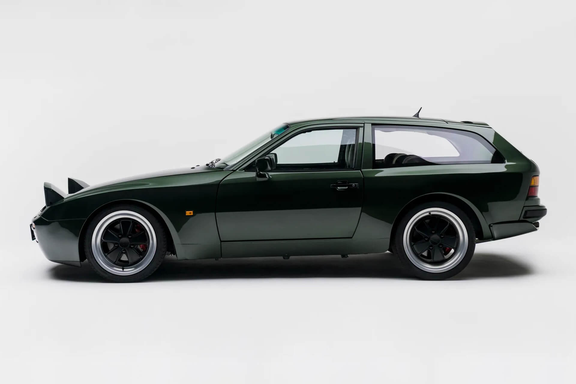 green 944 station wagon on white background